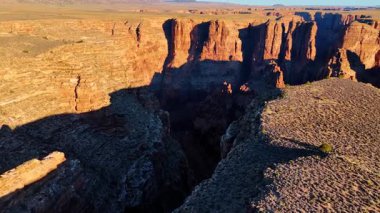 Footage over the edge of the canyon with steep cliffs. View on the river at the bottom of the dark canyon. Marble Canyon, Coconino County, Arizona, USA.