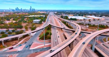 Austin, ABD, 24 Kasım 2025: Çok şeritli otobanın üzerinde, üzerinde trestler olan görüntüler. Birçok araba modern şehir manzarası boyunca yollar boyunca gider..