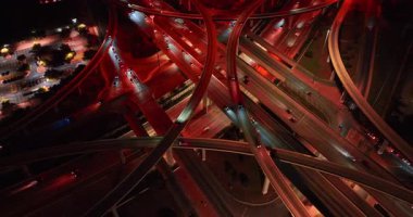 Yoğun bir yol kavşağı mesafesi gece kırmızıda parlıyordu. Bir sürü araba geçen sayısız otoyol ve trestler..