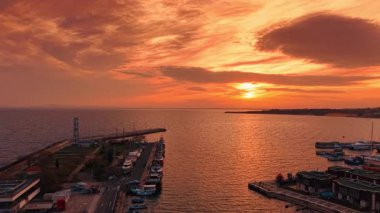 Karadeniz kıyısındaki birkaç tekneyle rıhtımdan uzakta. İnsansız hava aracı görüntülerinden deniz manzarası üzerinde fantastik gün batımı.