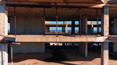 İnşaat halindeki binanın zemininde uçuş. Arkaplanda yeşil şehir manzarası.