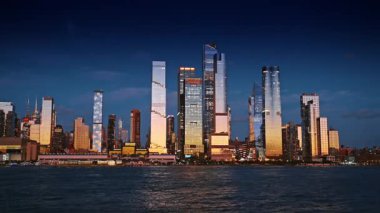 New York, ABD, 12 Aralık 2025: Gökdelenler ve gökdelenler batan güneşi yansıtıyor. Nehir manzarasından New York 'un göz kamaştırıcı siluetine bakın..