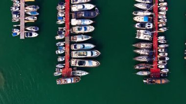 Deniz yeşili su manzarasındaki rıhtımlardaki küçük ve büyük tekneler. Üst Manzara. Gemili liman.