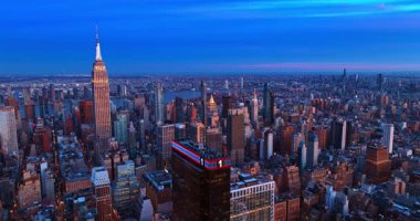 Alacakaranlıkta New York 'un düz sokağına iniyoruz. Empire State Binası 'nın batan güneş ışınlarına bakın..