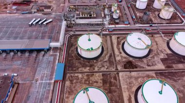 Alicante, Spain, 8 February 2026: Fuel loading terminal. Storage tanks and truck loading bay at a petroleum facility with tanker trucks.