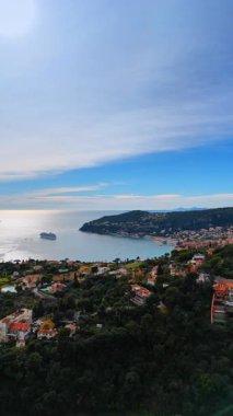 Cityscape of Nice, France scattered on the rocky coast of the Mediterranean Sea. Picturesque scenery of the city from drone. Vertical video.