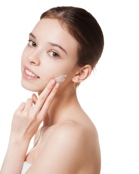 Young brunette using body lotion. — Stock Photo, Image