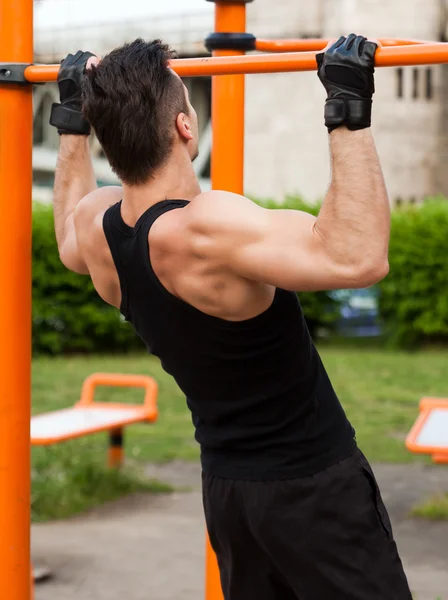 Outdoor workout on bars. — Stock Photo, Image
