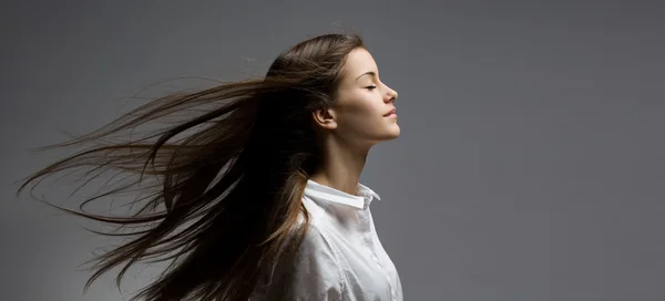 Brunette beauty with windswept hair. Stock Photo