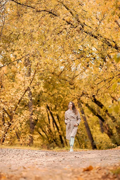 Caucasian Girl Pink Coat Blue Jeans Holes Dances Autumn Park — Stock Photo, Image