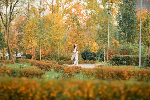 Caucasian Girl Pink Coat Blue Jeans Holes Dances Autumn Park — Stock Photo, Image