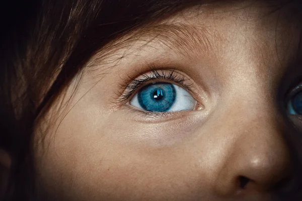 Blue eye of a three-year-old Caucasian girl. Close-up