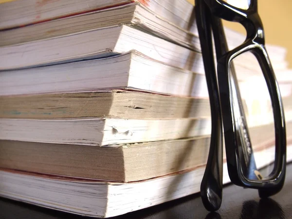 Pile of books and a pair of eyeglasses — Stock Photo, Image