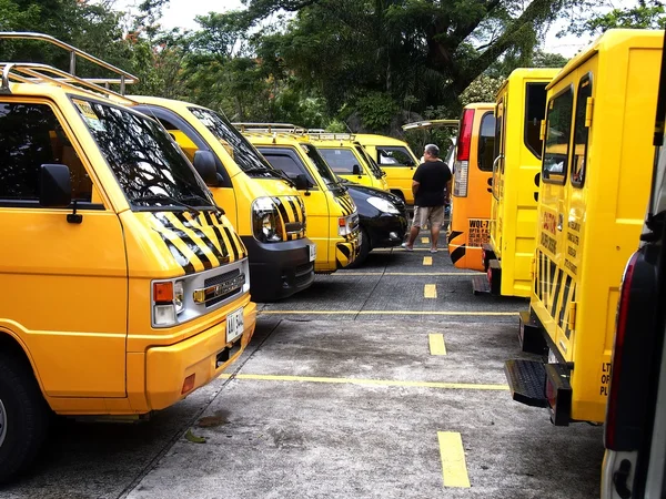 School service vehicles parked inside a school parking lot