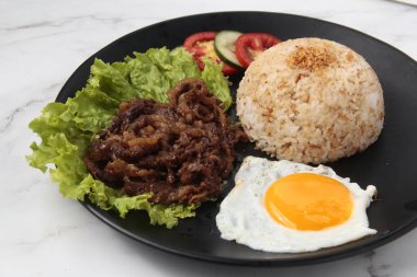 Tapsilog adı verilen tapa, sinangag ve itlog veya sığır eti, kızarmış pilav ve kızarmış yumurta anlamına gelen taze pişirilmiş Filipin yemeği fotoğrafı..