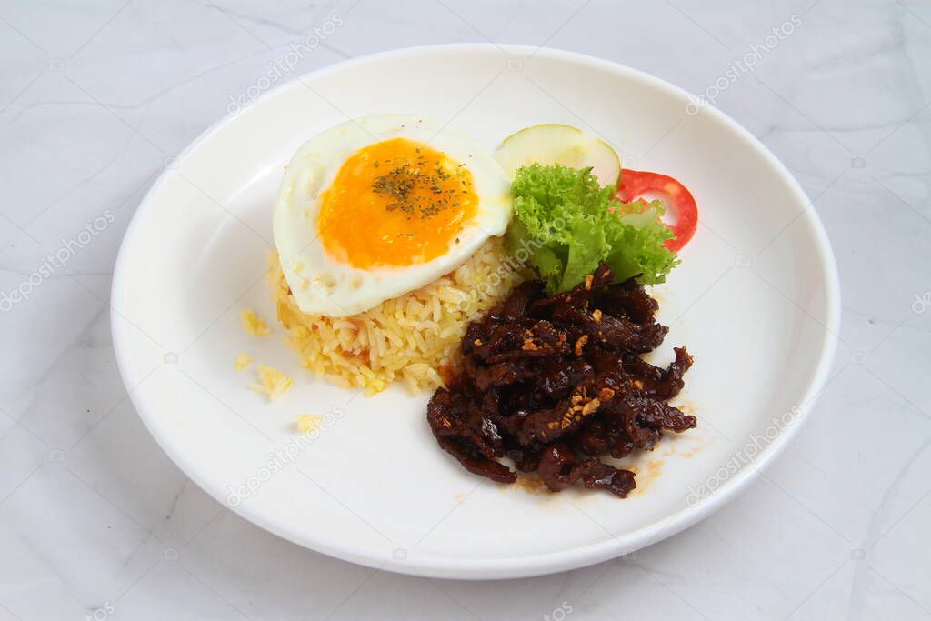 Photo of freshly cooked Filipino food called Tapsilog which stands for tapa, sinangag and itlog or beef, fried rice and fried egg.