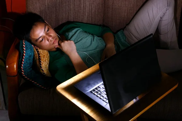 Asian teen watching video on a laptop — Stock Photo, Image