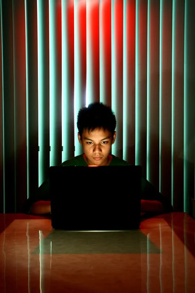 Young Teen in front of a laptop computer — Stock Photo, Image