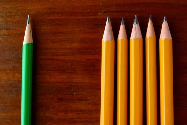 Five yellow pencils and one green pencil — Stock Photo, Image