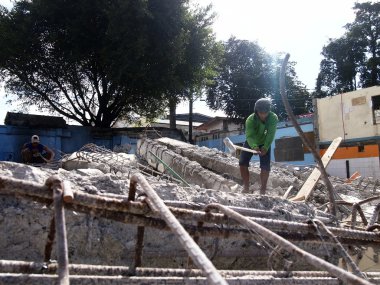 İşçi el ile eski bir bina yapısı yıkmak