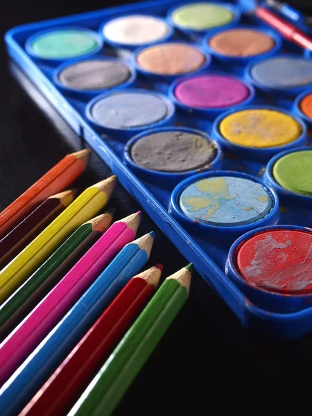 Pallette of water colors and colored pencils — Stock Photo, Image