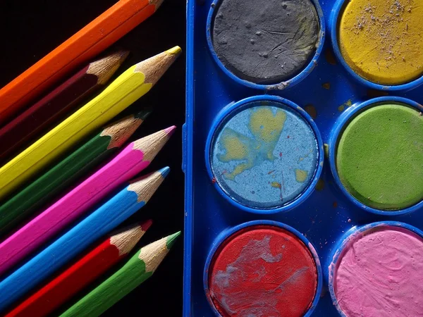 Pallette of water colors and colored pencils — Stock Photo, Image