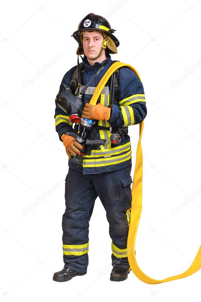 firefighter holds fire hose with fire nozzle in hands and looking at camera 