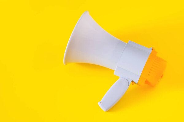 Electronic megaphone on yellow background.