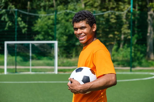 Portrét Mladého Usmívajícího Španělského Muže Držícího Fotbalový Míč Zatímco Stojí — Stock fotografie