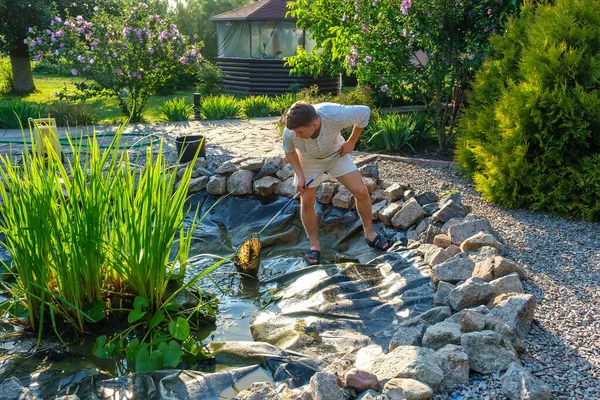 Young Caucasian Man Cleans Artificial Garden Pond Bottom Landing Net — Stock Photo, Image