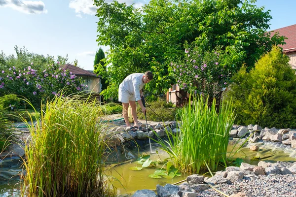 Young Caucasian Man Cleans Artificial Garden Pond Bottom High Pressure — Stock Photo, Image