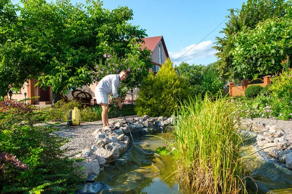 Young Caucasian Man Cleans Artificial Garden Pond Bottom High Pressure — Stock Photo, Image