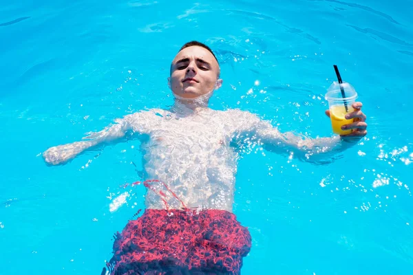 Uomo disabile con cocktail refrigerante in piscina — Foto Stock