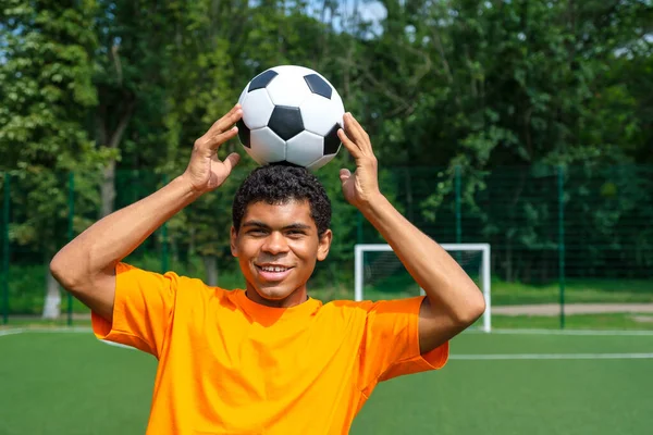 Brezilyalı futbolcu spor sahasında futbol topu kontrolünü geliştirir ve idman yapar. — Stok fotoğraf