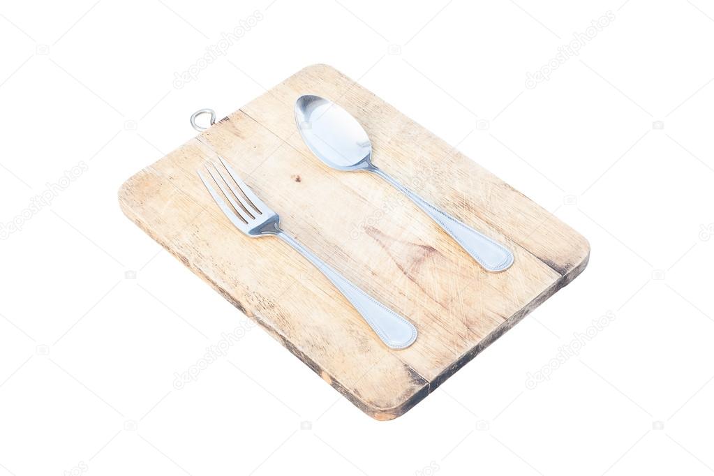 spoon and fork on cutting board