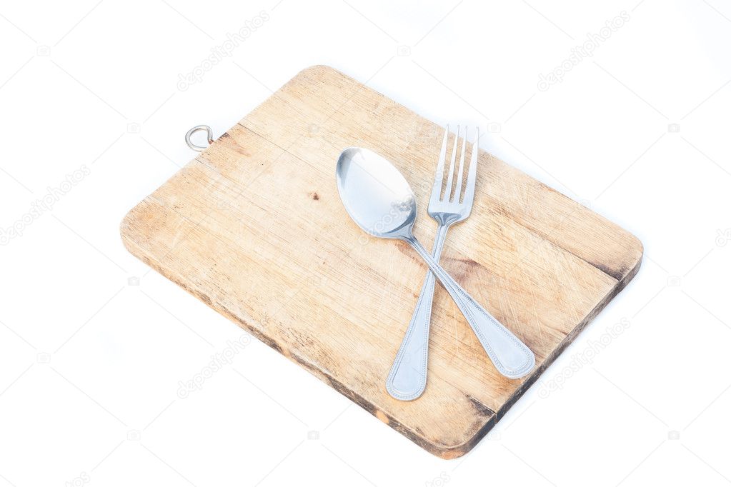 spoon and fork on cutting board