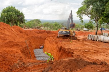 Brasilia, Brezilya-29 Ekim 2020: Noroeste 'nin kuzeybatısında kanalizasyon borusu döşeyen Ağır Görev Makineleri kazıcısı.
