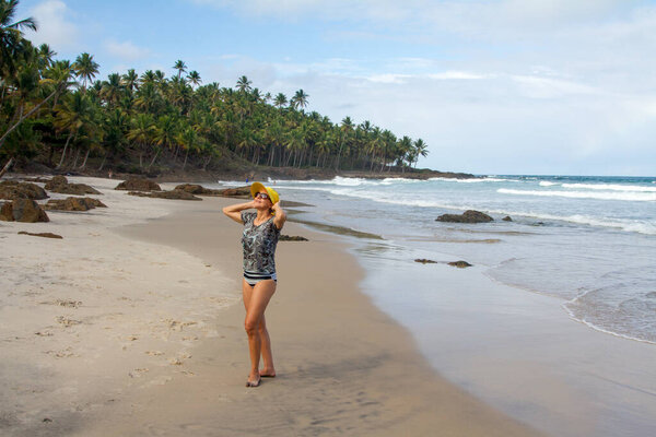 Woman enjoying herself at one of the many nearly deserted beaches in Brazil