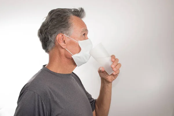 Senior Man Trying Drink Water While Still Wearing His Surgical — Stock Photo, Image