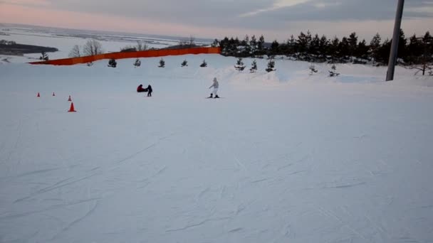 Přeplněné turisty baví aktivity Lesní lyžařské středisko. Lidé sjíždějí ze svahů na lyžích a snowboardu. Horské lyžařské středisko. zimní sporty — Stock video