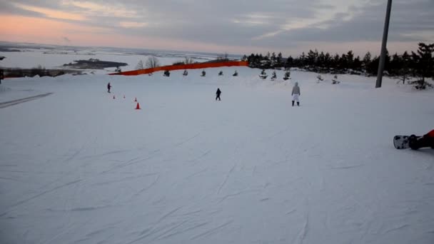 Толпы туристов наслаждаются мероприятиями Forest Ski Resort. Люди катаются на лыжах и сноуборде по склонам. Горнолыжный курорт. зимний спорт — стоковое видео