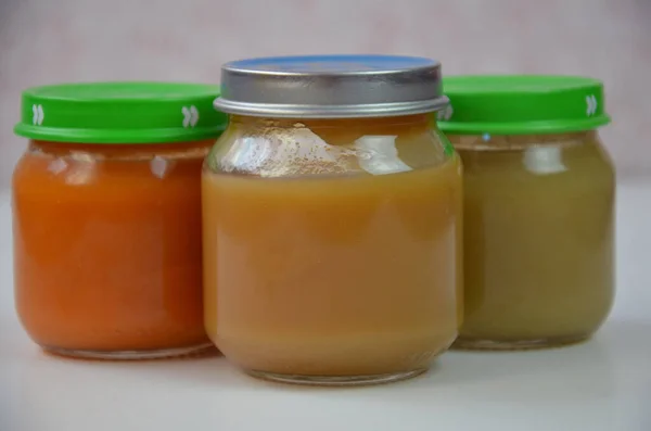 Three jars of baby food on white. — Stock Photo, Image