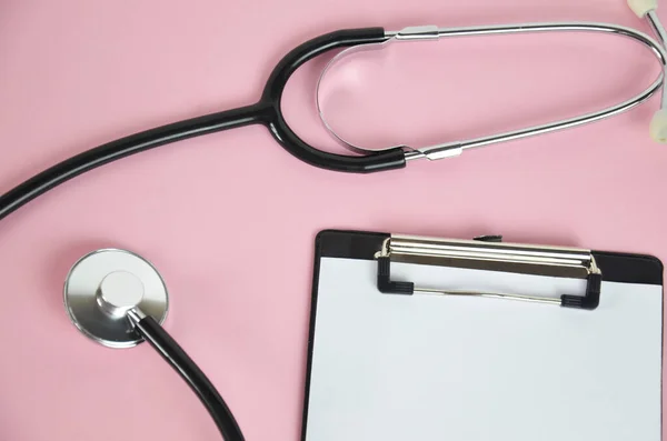 Masa başında dizüstü bilgisayarlı stetoskop, hastanede reçete, sağlık ve tıbbi konsept yazan doktor, arka planda test sonuçları, klasik renk, seçici odak