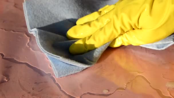 Close up of hands in rubber protective yellow gloves cleaning the white surface with a rag. Home, housekeeping concept — Stock Video
