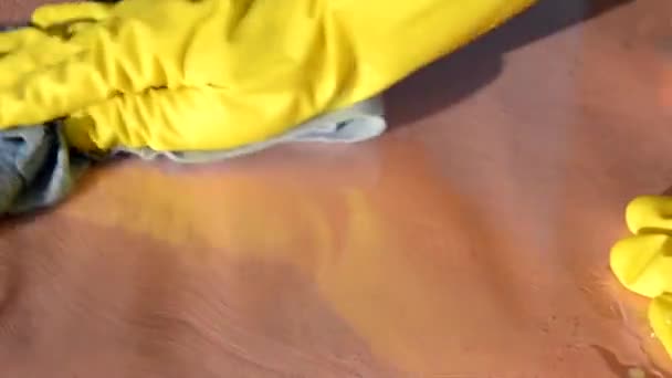 Close up of hands in rubber protective yellow gloves cleaning the white surface with a rag. Home, housekeeping concept — Stock Video