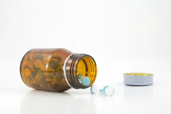 Pills pouring out of the brown bottle — Stock Photo, Image