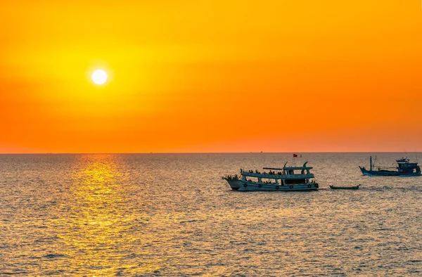 Sunset on the beautiful bay when the fishing boat faces the sun is also the end of the day at the pearl island of Phu Quoc, Vietnam.