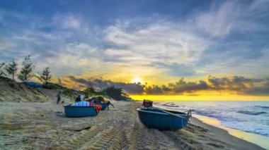 Time-lapse Fishing boat to dawn on the beautiful beach on a summer morning on a tropical beach near Mui Ne, Vietnam