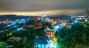 Night scene in the valley with bright houses with colorful lights makes the night scene in the countryside Vietnam