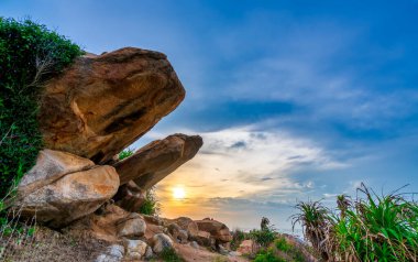 Abstract rocky beach with sunrise to greet the new day in the beautiful sea